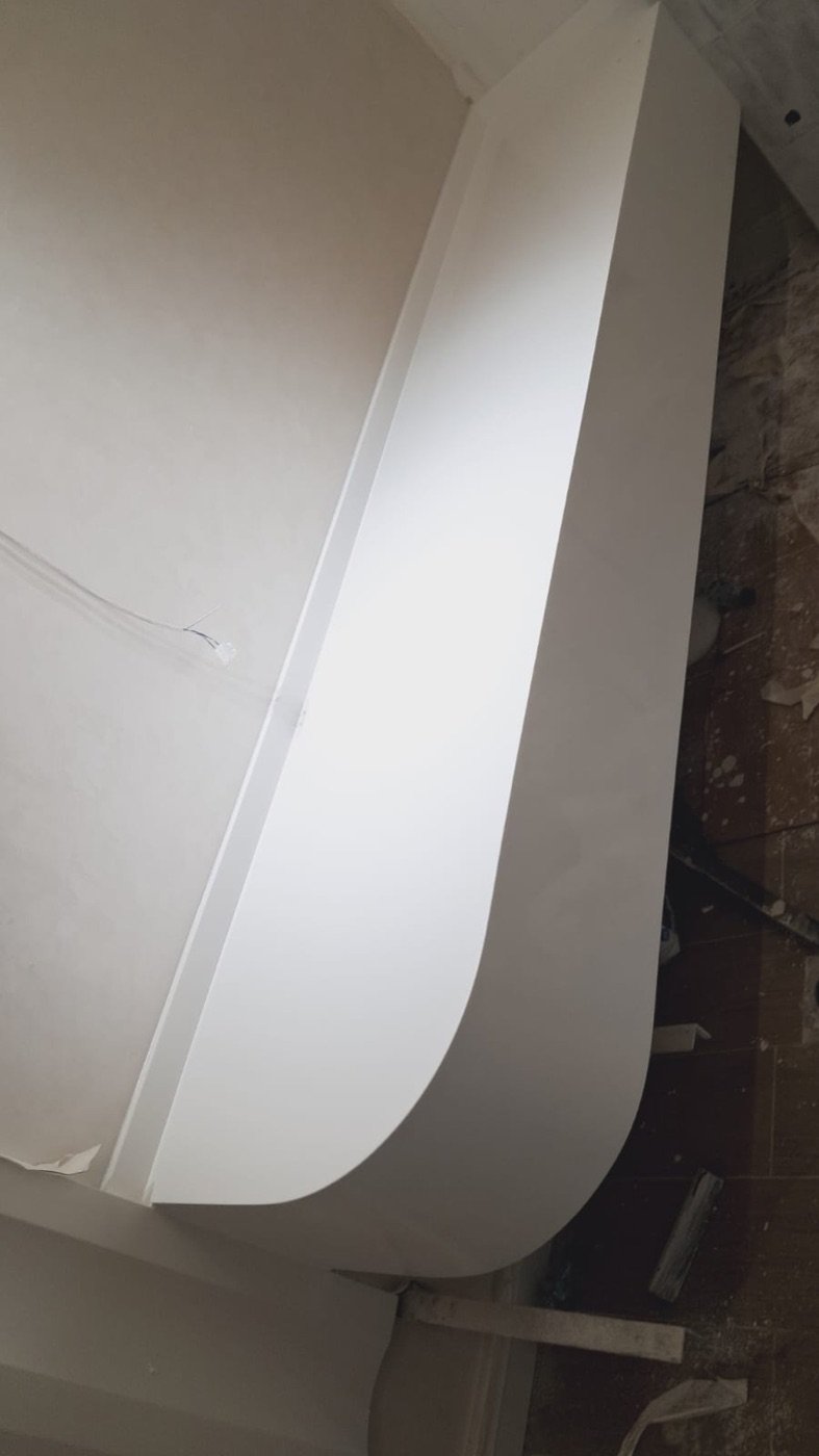 Curved seamless solid-surface wall cladding installed in a commercial interior