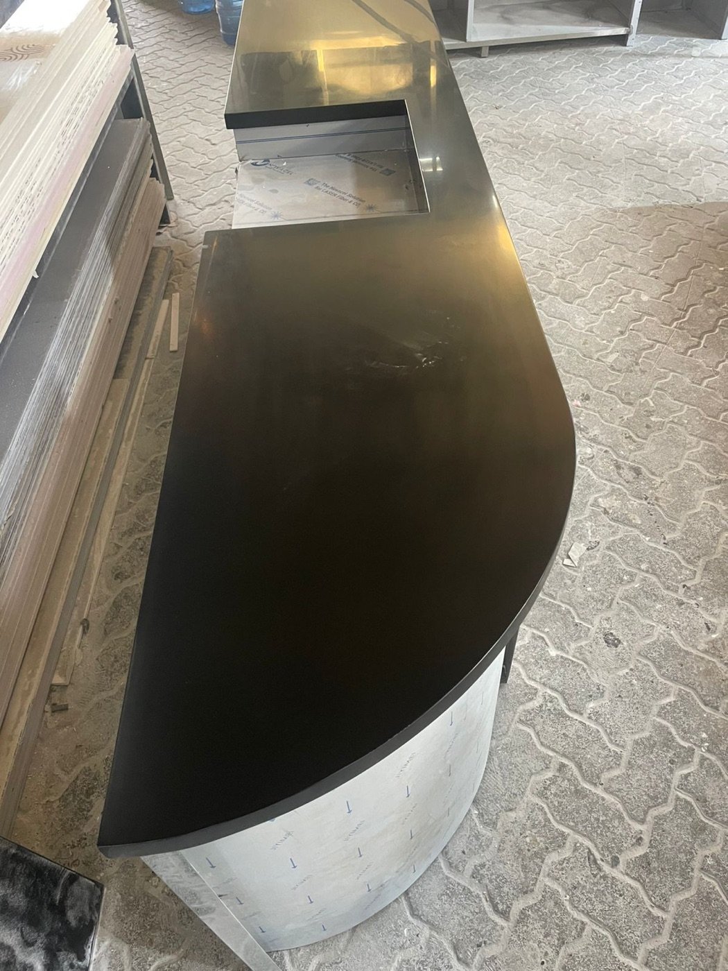 Curved Corian reception counter with contrasting top, installed in the UAE