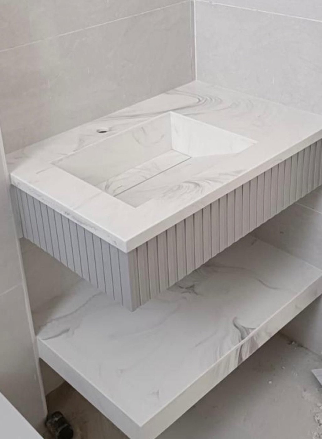Corian marble-look bathroom vanity with fluted detail, installed in the UAE