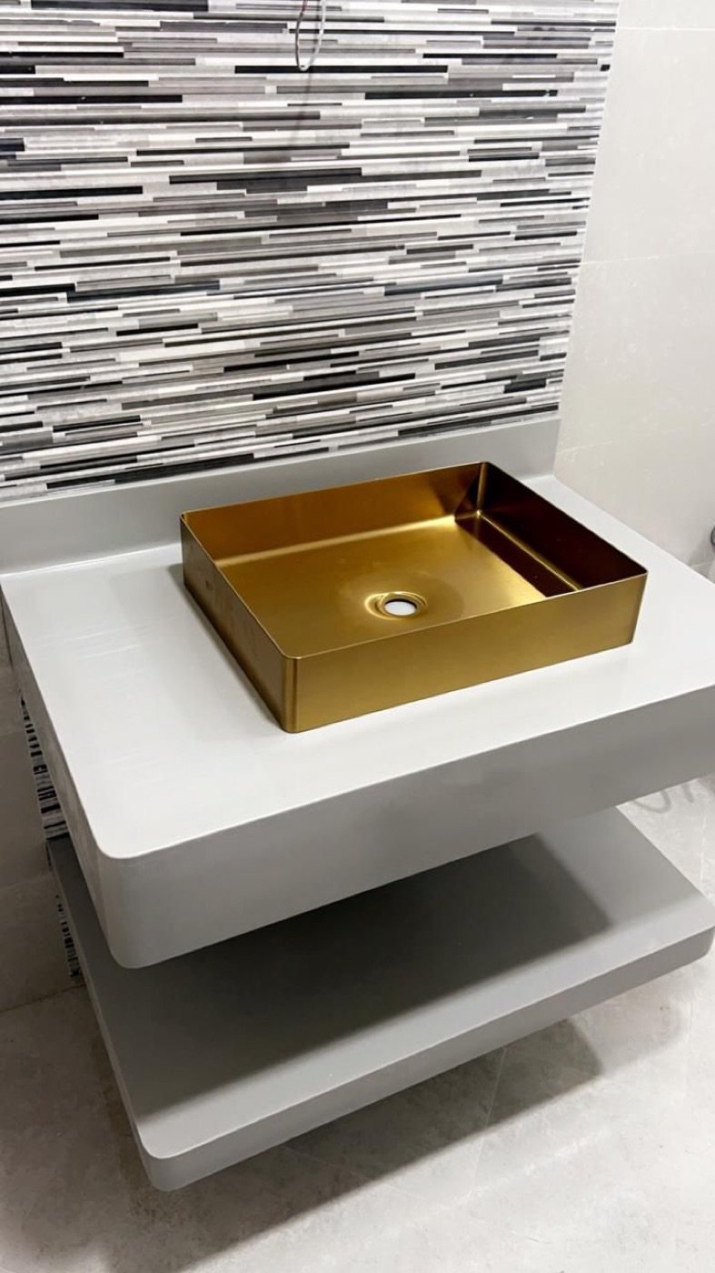 Seamless Corian floating bathroom vanity with gold vessel basin, UAE