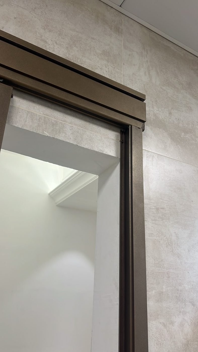 Detail of the frame and header of the sliding washroom door