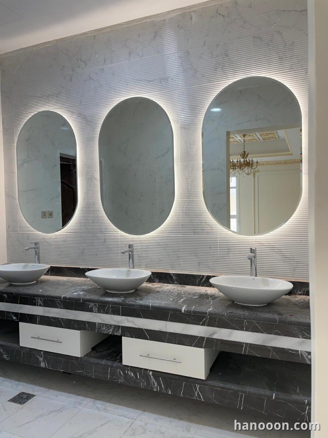 Custom glass and mirror work by Hanooon — backlit LED mirror, etched or fluted glass, completed installation Abu Dhabi UAE