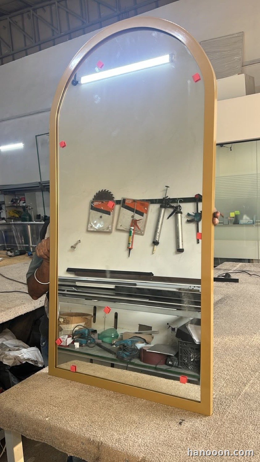 Custom glass and mirror work by Hanooon — backlit LED mirror, etched or fluted glass, completed installation Abu Dhabi UAE