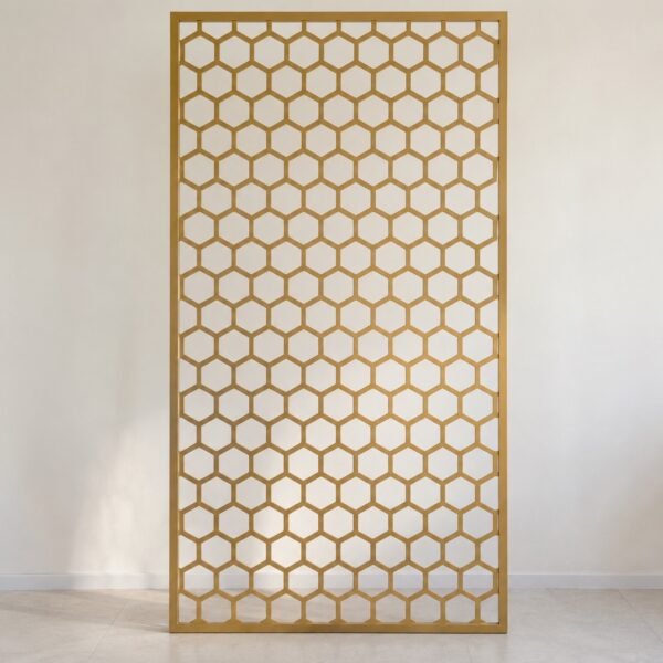 Champagne-gold laser-cut steel hexagon room divider shown straight-on against a plain light wall.