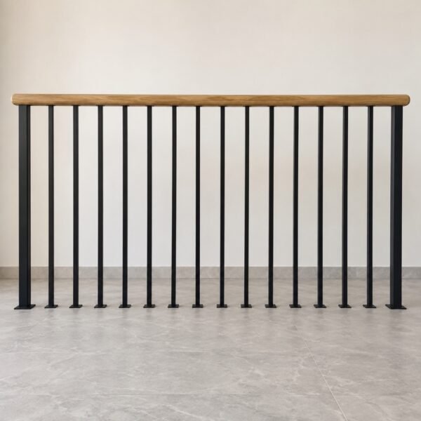 Black vertical bar stair railing with rounded oak handrail on a light floor