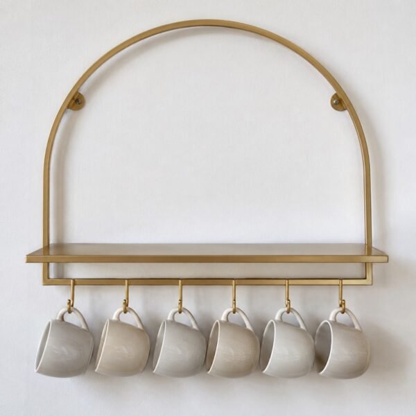 Gold arch steel cup rack shelf with six hanging cups on a plain white wall