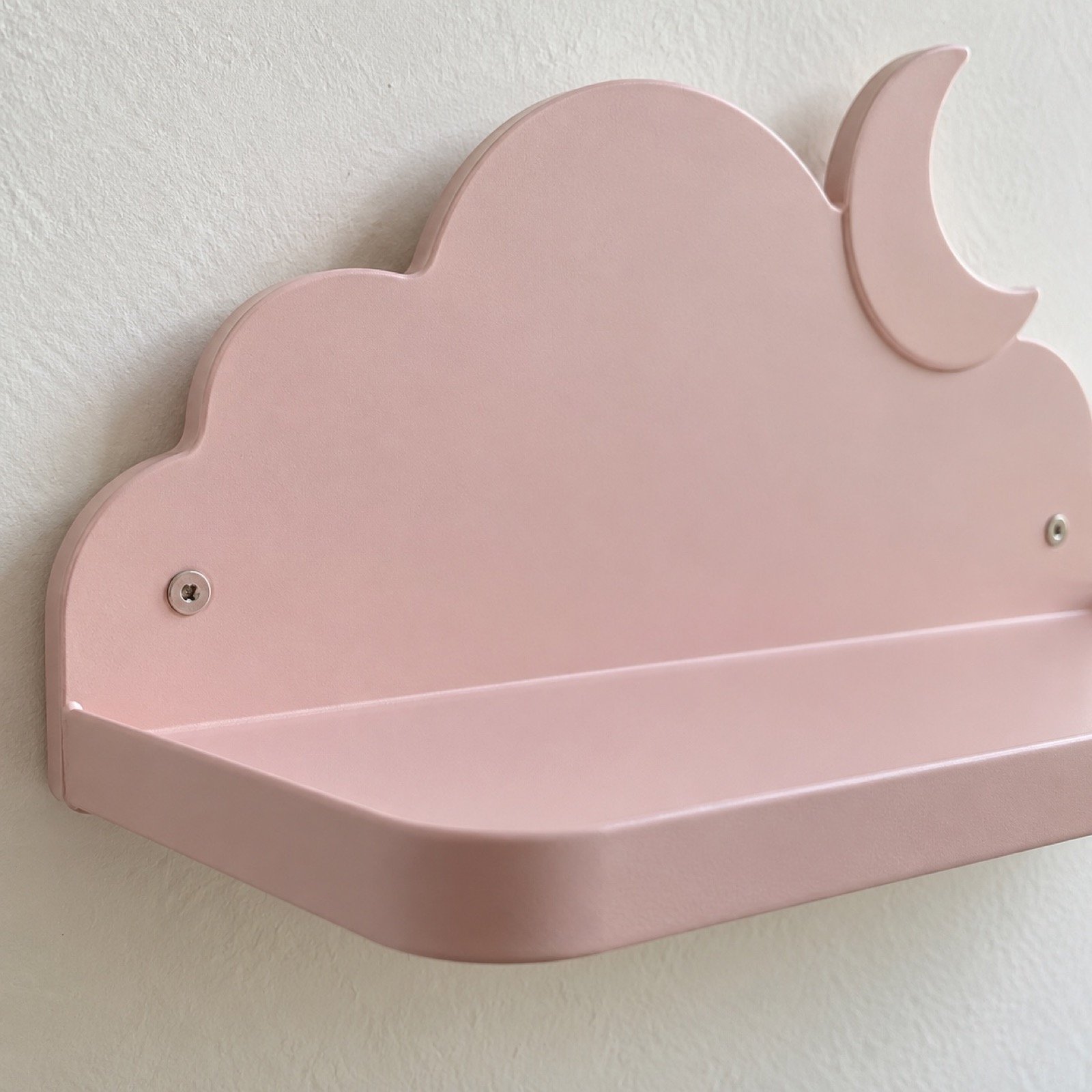 Close-up of the smooth powder-coated steel edge and finish on a cloud and moon wall shelf