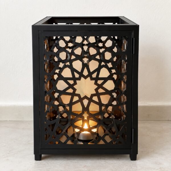 Square matte black laser-cut steel Mashrabiya tea-light lantern on a light floor