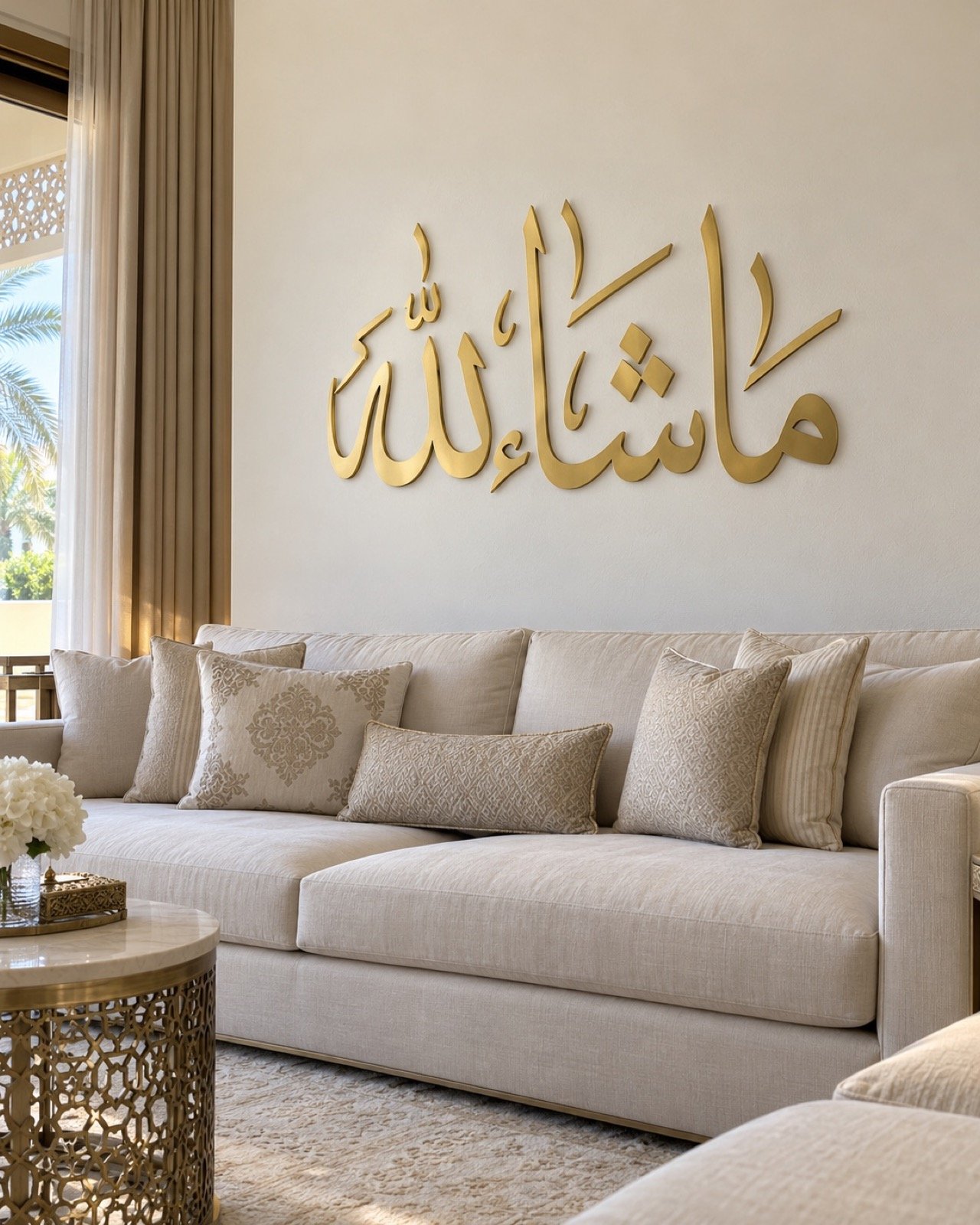 Gold Ma Sha Allah Thuluth wall art mounted above a cream sofa in a UAE villa majlis.