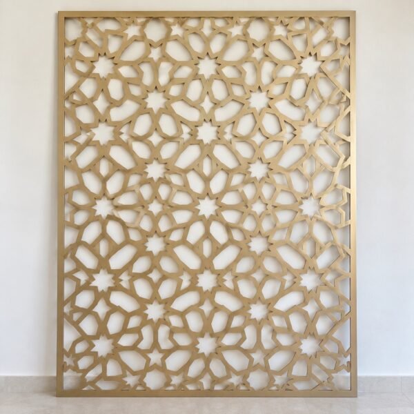 Front view of a champagne aluminium geometric mashrabiya facade screen panel on a plain white wall.