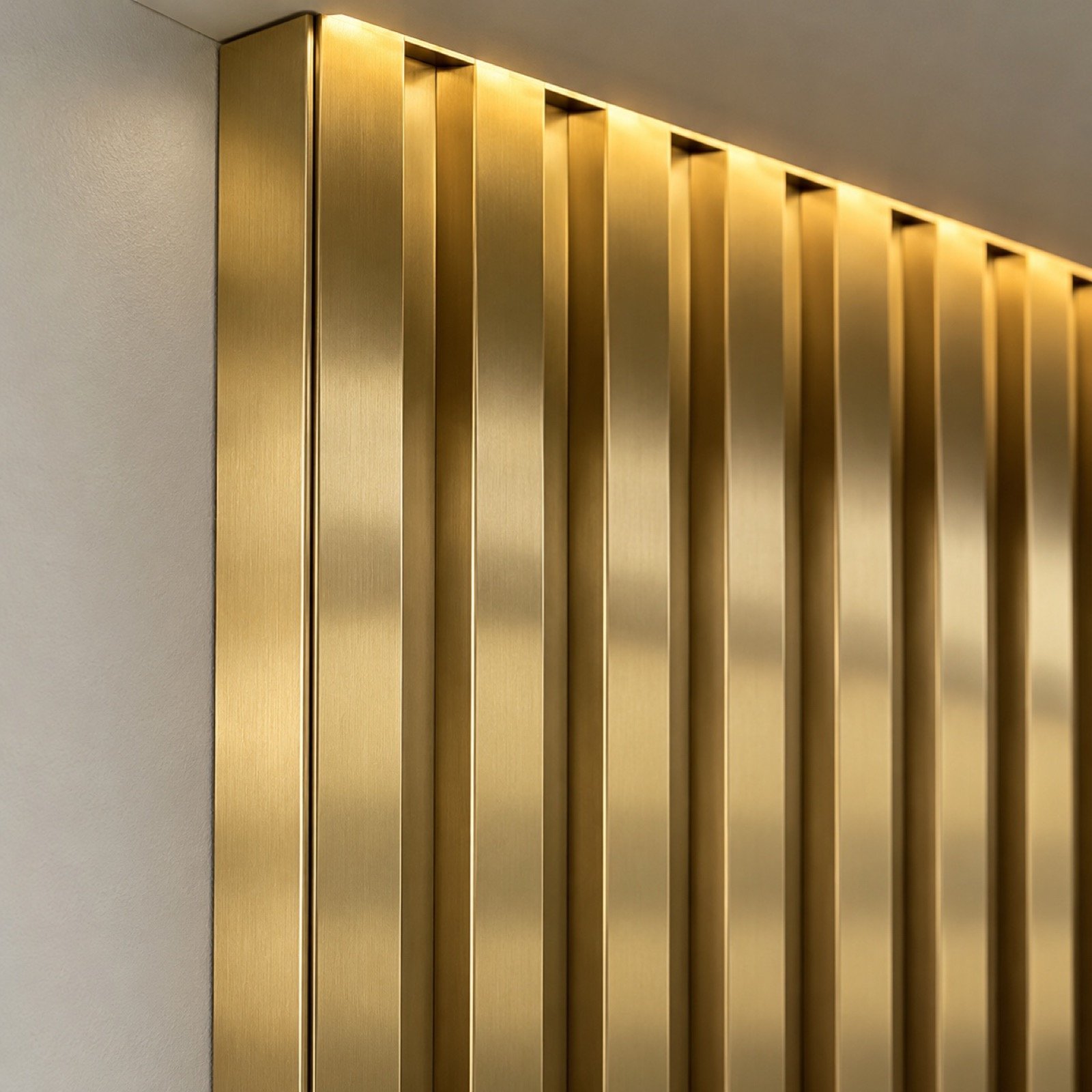 Close-up of the gold PVD stainless-steel flutes, panel edge, seam, and warm LED glow