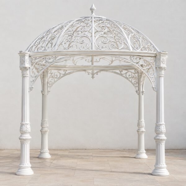 White cast aluminium garden gazebo with ornate arches and domed roof on light paving