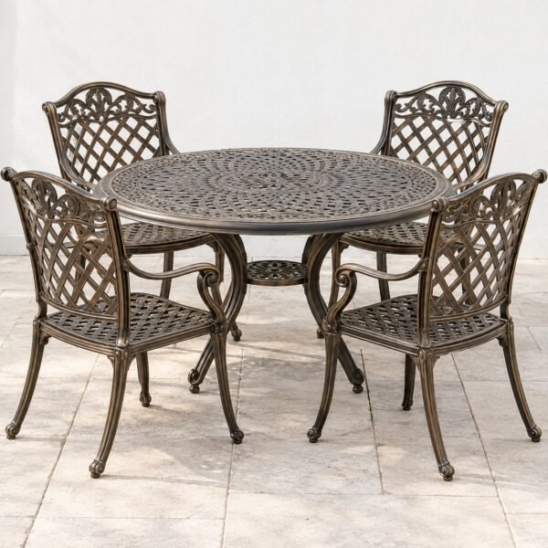 Cast aluminium garden dining set with round table and four antique bronze chairs on light paving