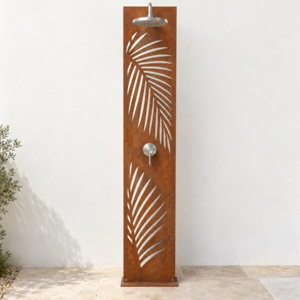Freestanding corten steel outdoor shower panel with palm frond cut-outs and stainless fittings against a white wall.
