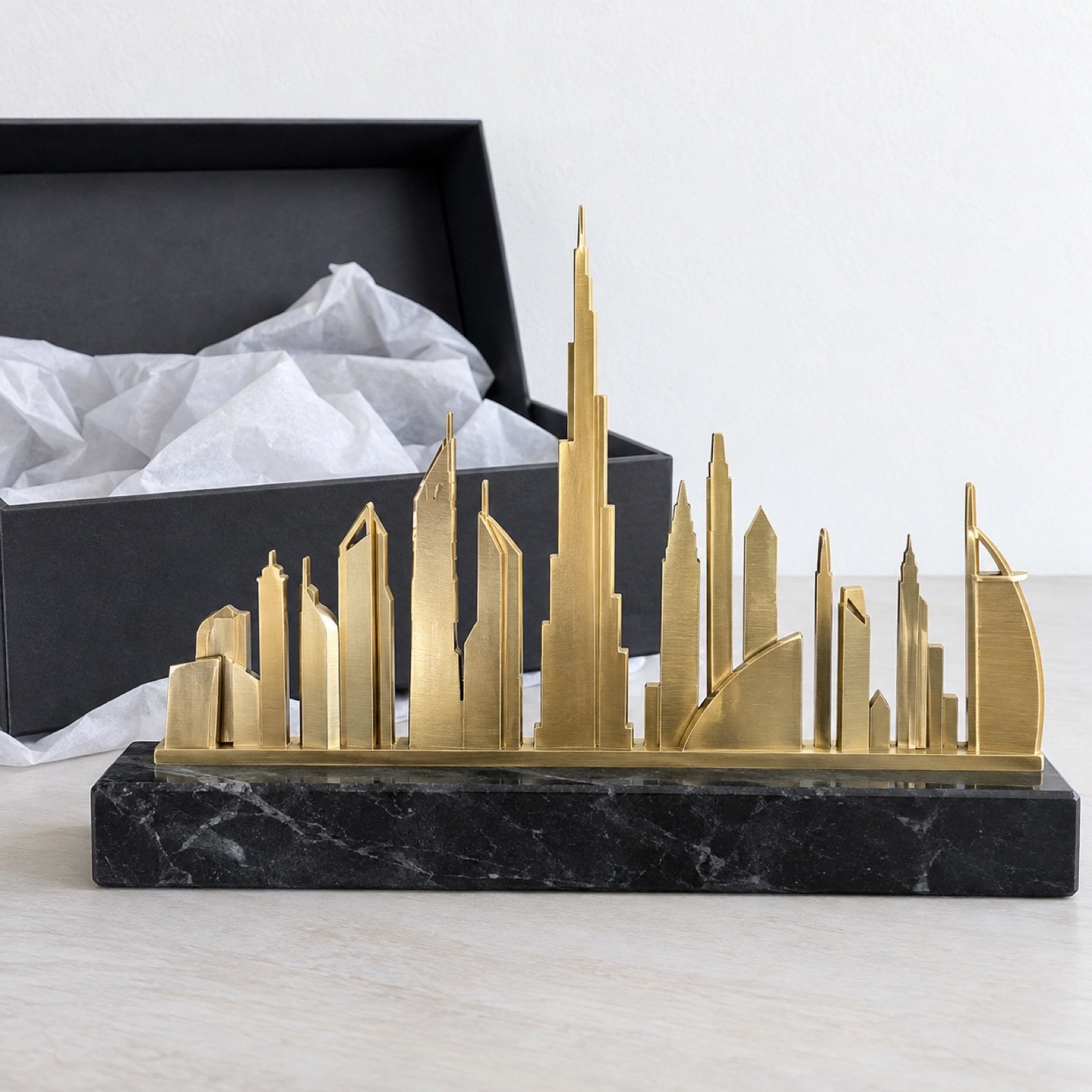 Mini Dubai skyline desk sculpture in brushed brass on a black marble base with a gift box