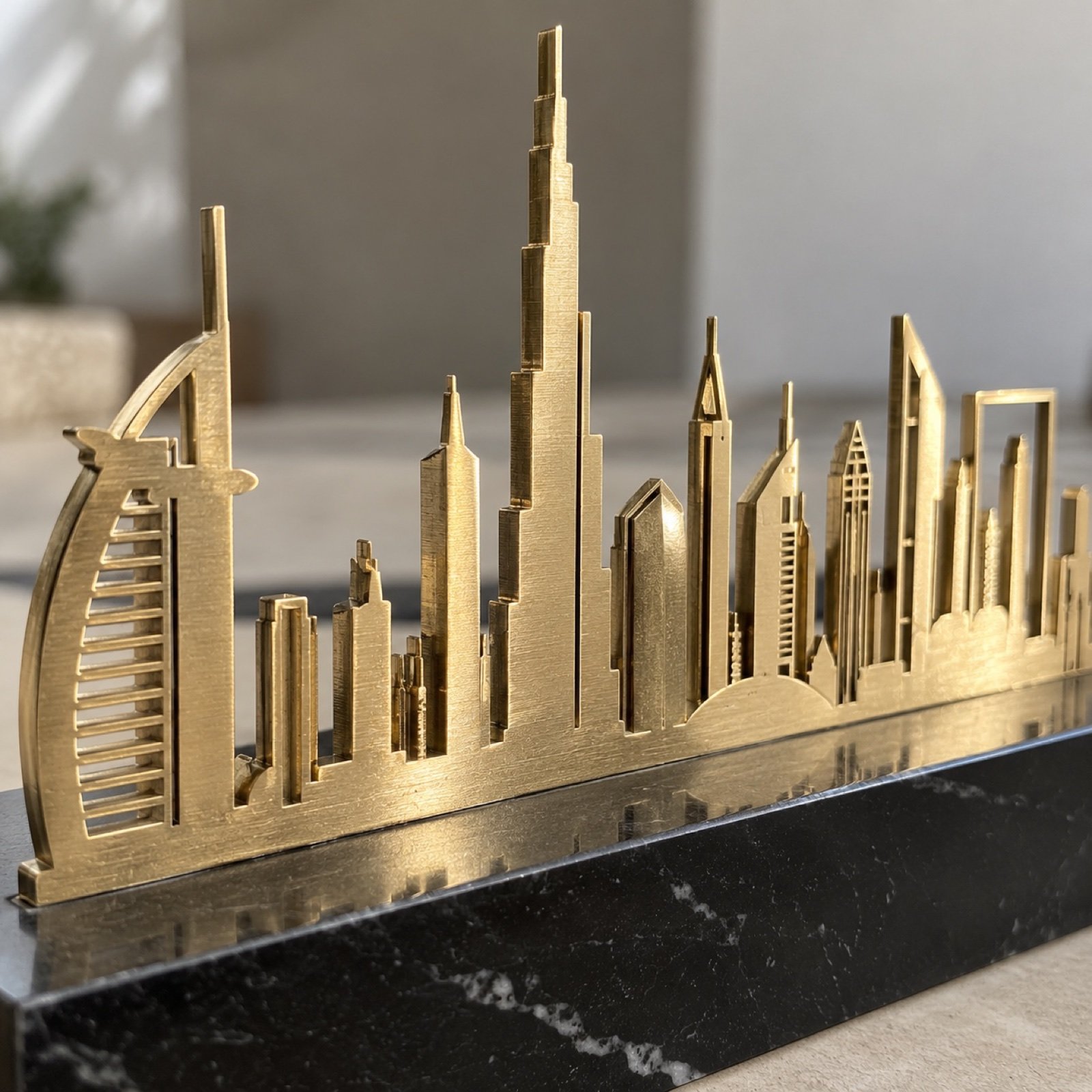 Close-up of the brushed brass skyline edge and black marble base