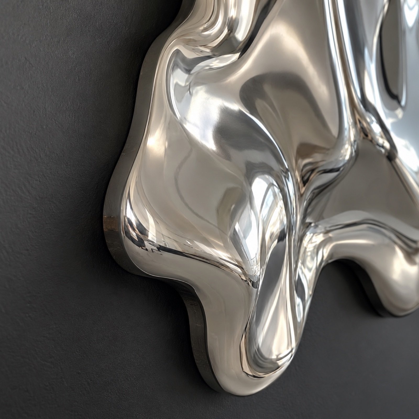 Close-up of the polished stainless steel edge and flowing chrome surface