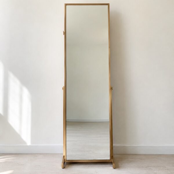 Full-length champagne-gold jewellery armoire mirror standing against a plain white wall