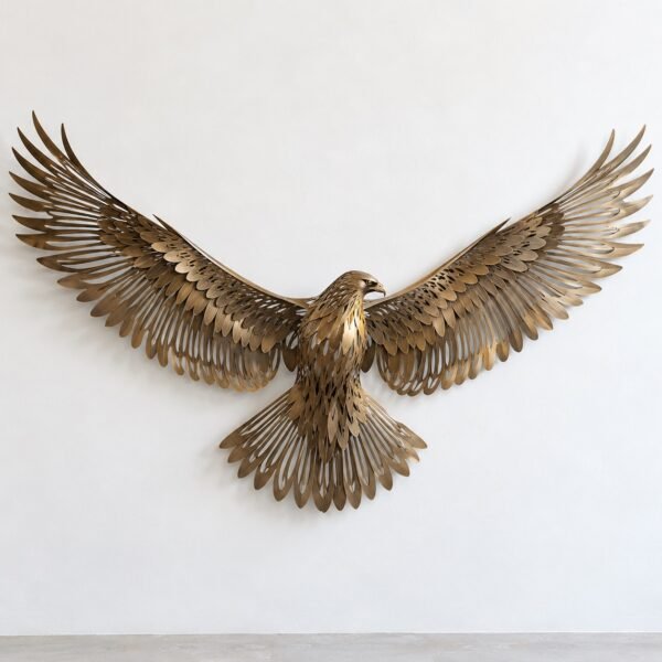 Brushed bronze PVD steel falcon wall sculpture with fine laser-cut feather lines on a white wall.