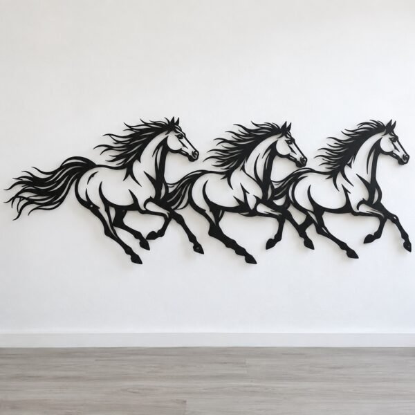 Three galloping Arabian horses in a matte black steel wall frieze on a plain white wall.