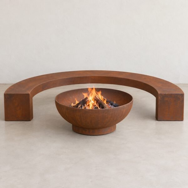 Front view of the N052 curved corten-finish steel fire bowl surround bench on a light floor.