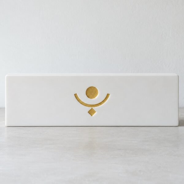 White Corian desk plaque with an original gold-filled abstract engraving, front view