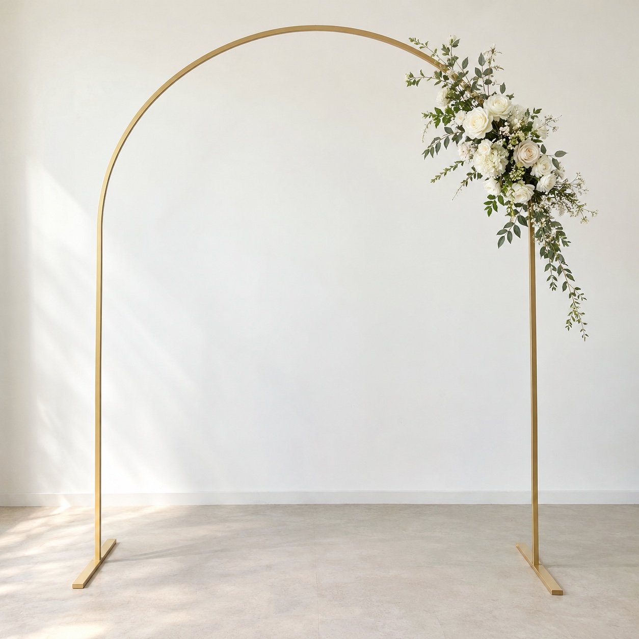 Gold rounded arch backdrop frame in satin gold metal finish on a light floor