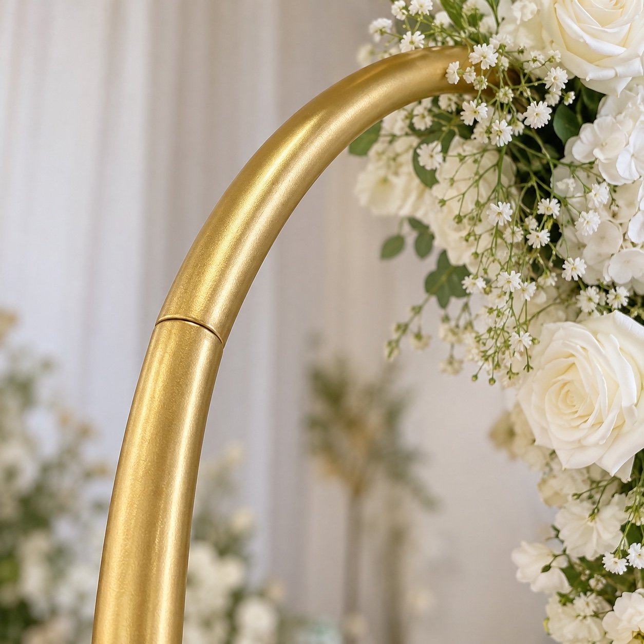 Close-up of the satin gold powder-coated metal edge and floral detail on the arch frame