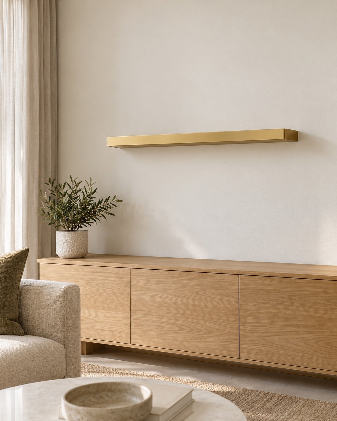 brushed gold floating steel shelf mounted in a modern living room