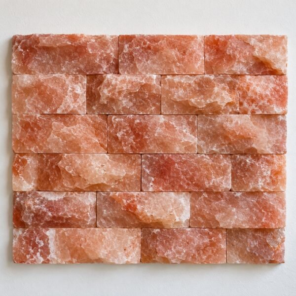Rock-face pink Himalayan salt cladding tiles in stacked rows on a plain white wall