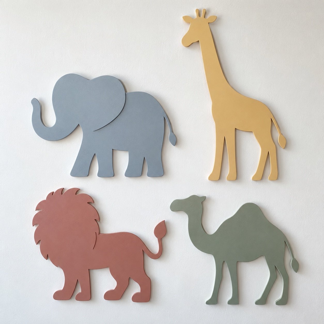 Four pastel steel safari animal silhouettes on a white wall