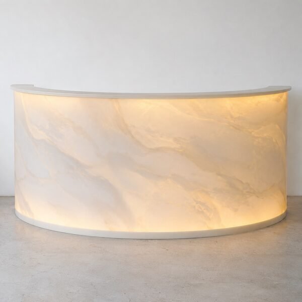 Curved translucent Corian bar counter front with warm backlight on a plain white wall