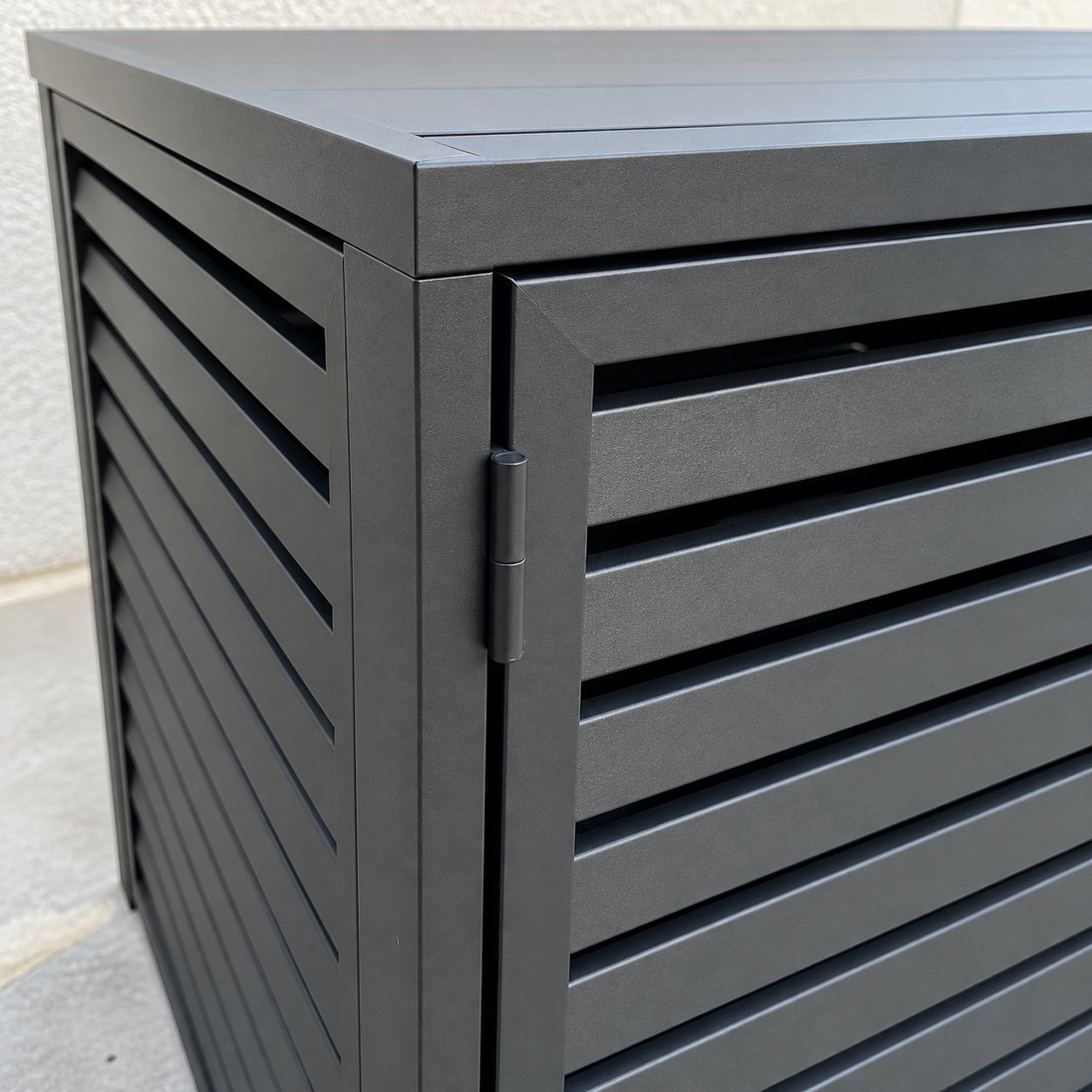 Close-up of the matte black aluminium louvres, edge, hinge, and powder-coated finish.