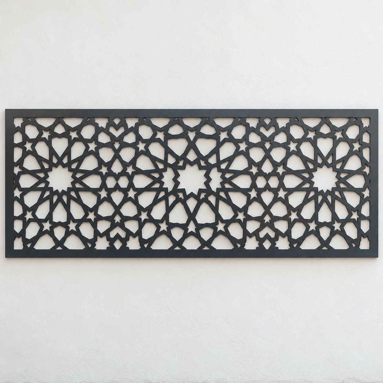 Front view of an anthracite Islamic geometric laser-cut villa wall fence infill panel on a plain white wall.