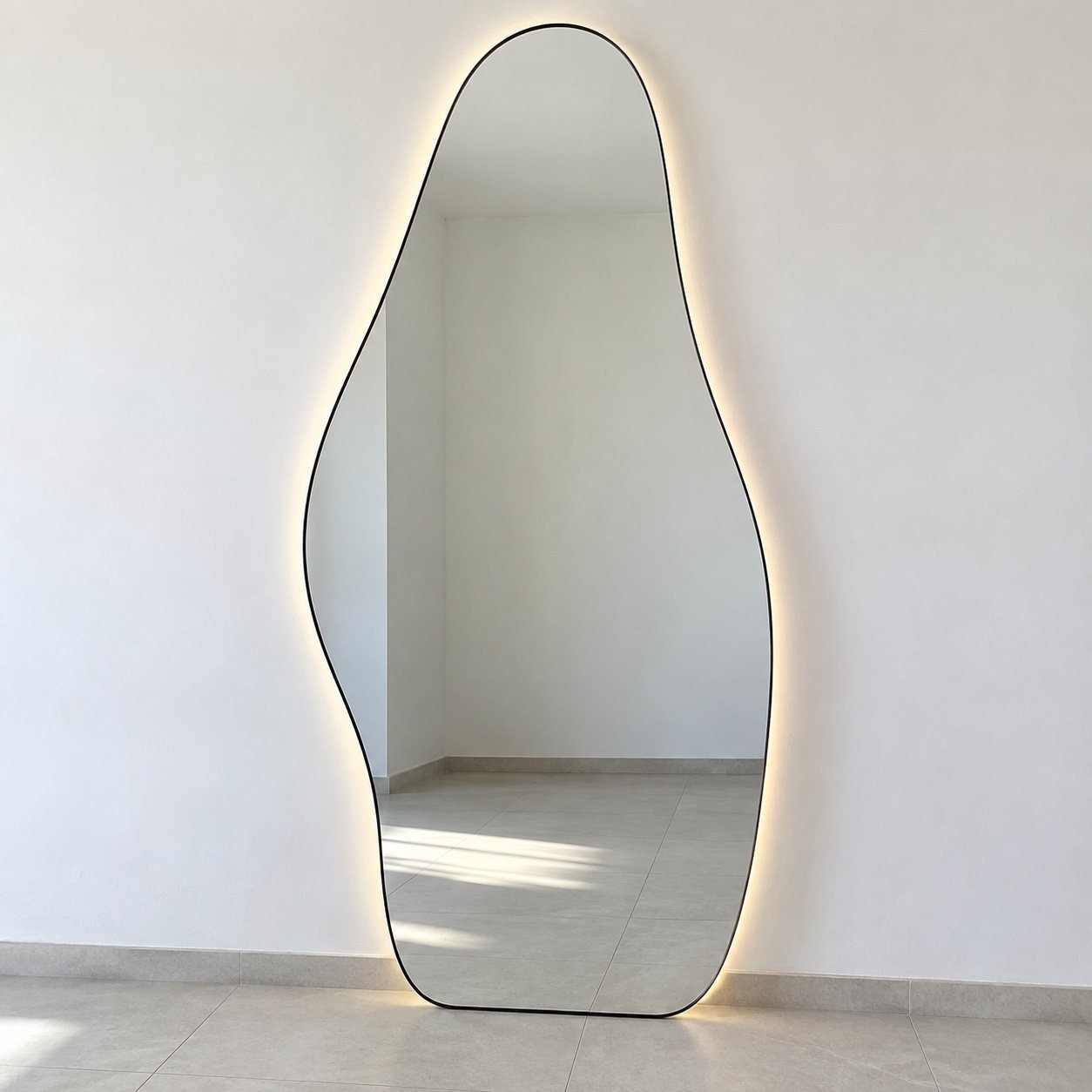 Sculpted Halo organic LED floor mirror standing against a plain white wall
