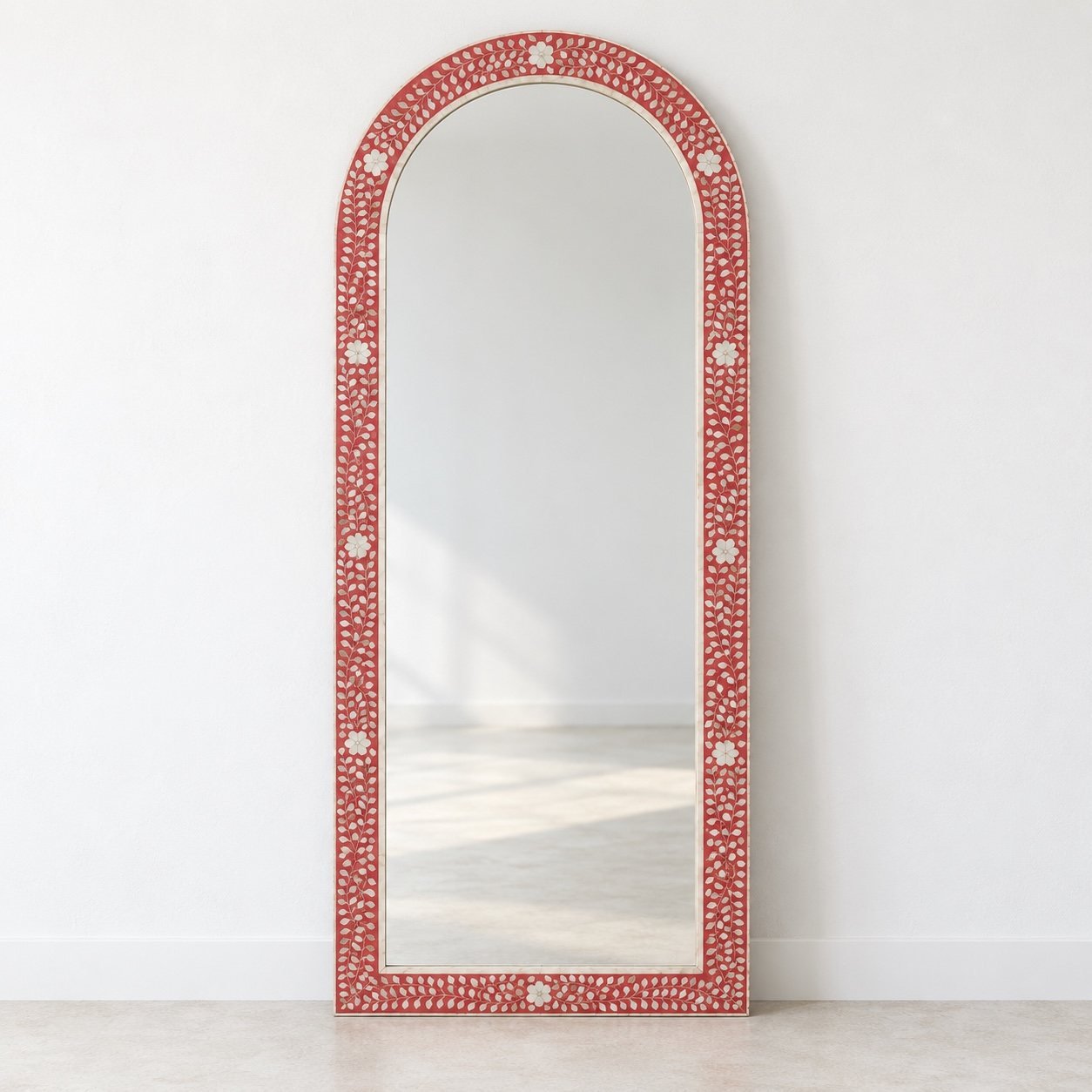 Ayla arched floor mirror with raspberry-red floral inlay frame against a white wall
