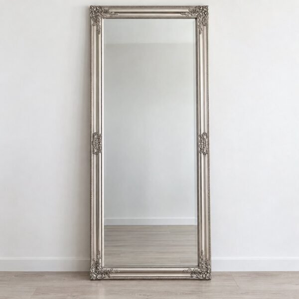 Noura ornate silver rectangular leaner mirror standing against a plain white wall