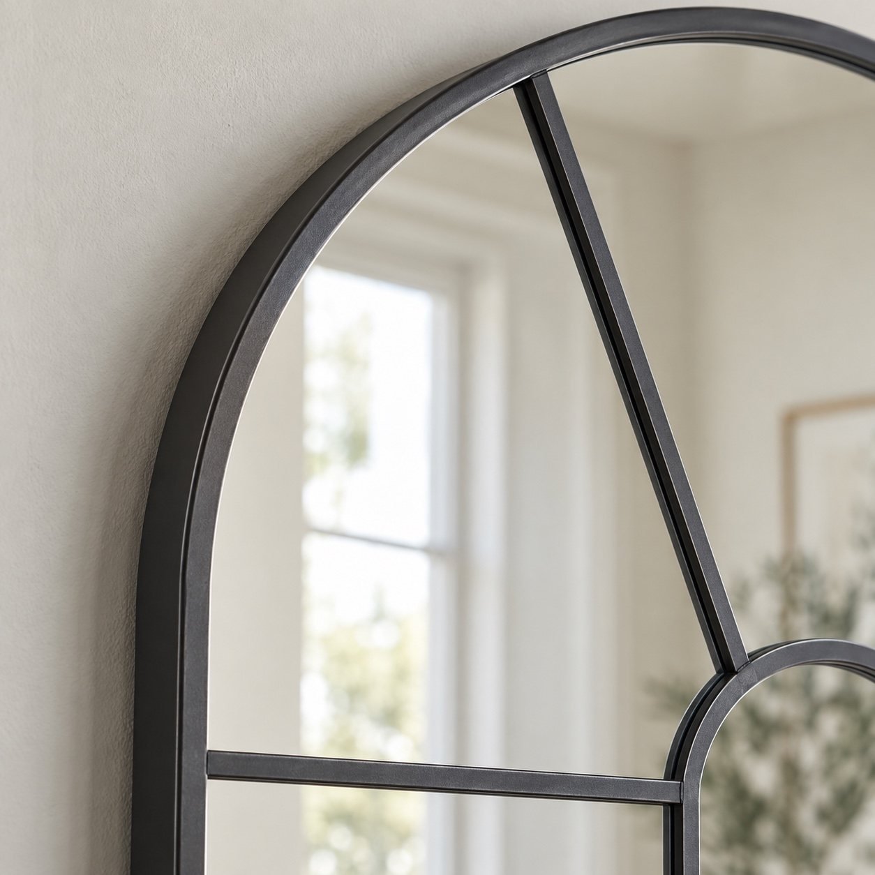 Close-up of the clean charcoal metal frame corner and mirror glass edge