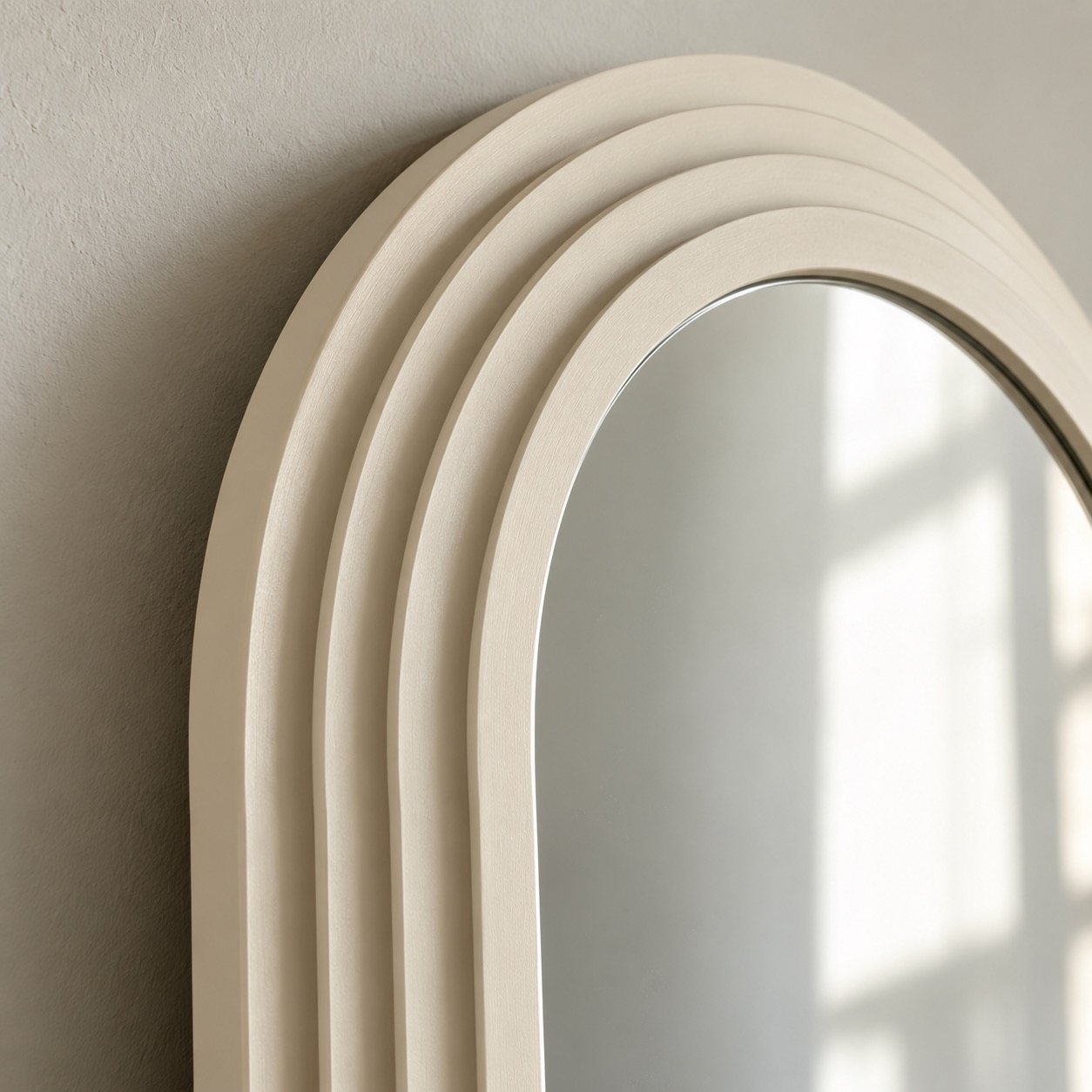 Close-up of the layered ivory frame corner and clean mirror edge