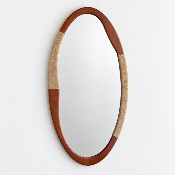 Oval wall mirror with a warm reddish-brown wood frame and beige jute wrapping on a white wall.