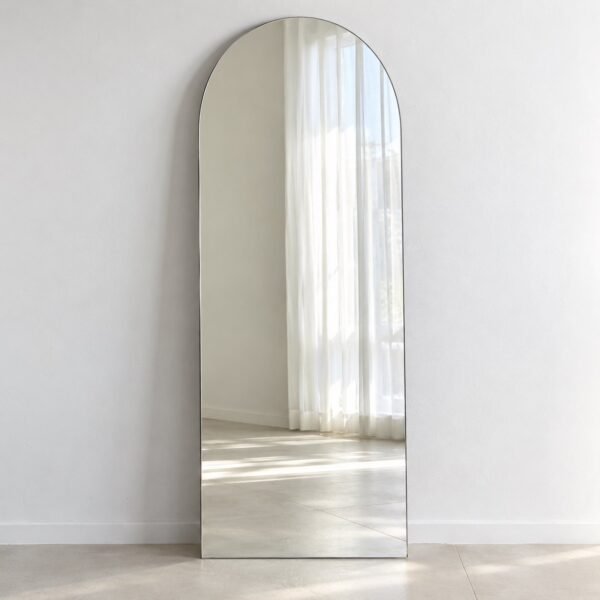Safa Arch charcoal-edge leaner mirror standing against a plain white wall