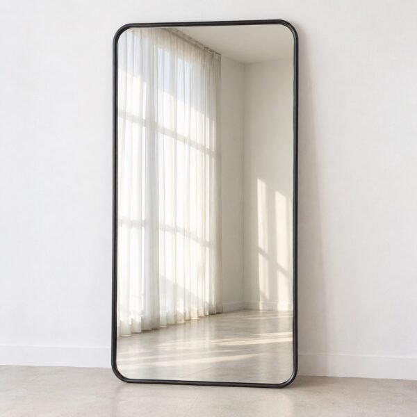 Safa full-length rounded rectangular leaner mirror with a dark charcoal metal frame against a white wall