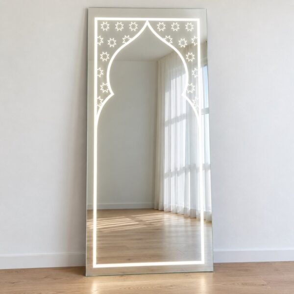 Frameless Noor Arch LED leaner mirror standing against a plain white wall
