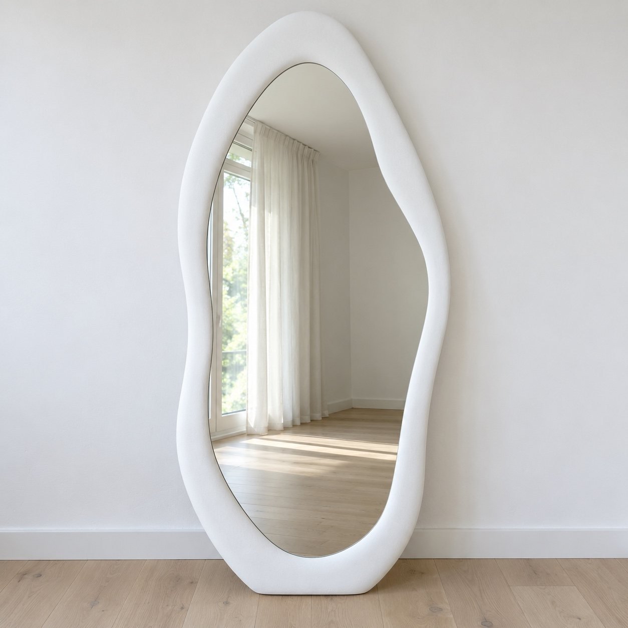 Noor organic floor mirror with a thick matte white frame against a plain white wall.