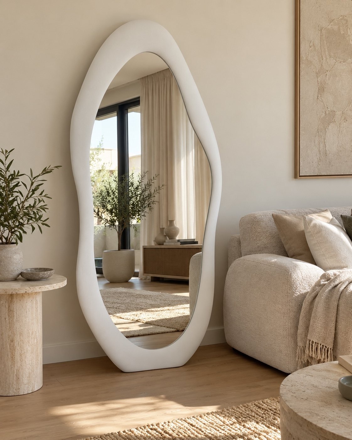 Noor white organic floor mirror standing beside a neutral sofa in a natural living room.