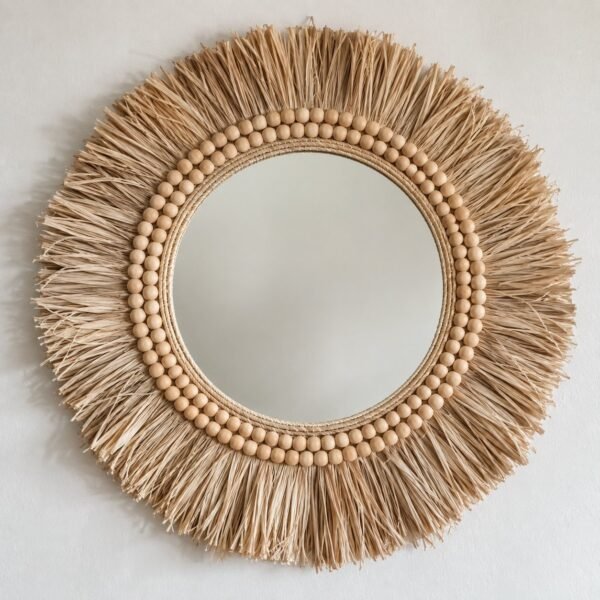 Riwa Sunburst round wall mirror with natural rattan, straw fibre and wood bead frame on a plain white wall