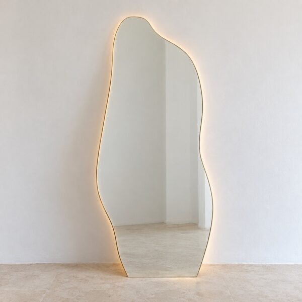Swayline organic champagne-gold LED floor mirror standing against a white wall
