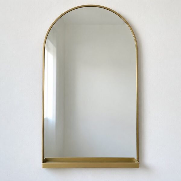 Front view of a 50 x 90 cm arch-top mirror with a slim gold frame and integrated bottom shelf on a white wall.