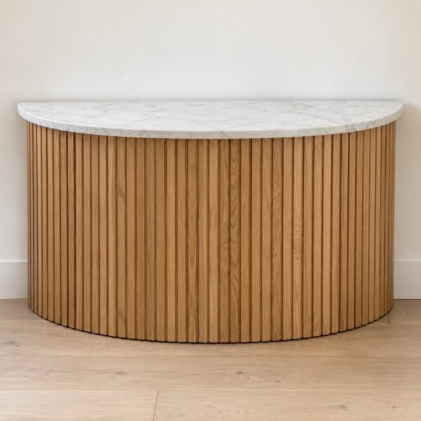 T40 curved half-moon console table with fluted solid oak base and white marble top against a plain white wall.