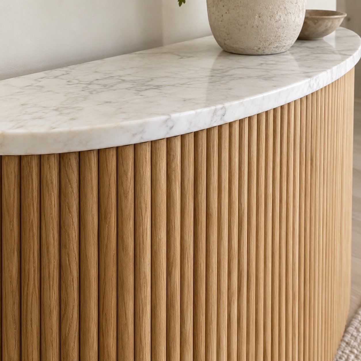 Close-up of the T40 console table’s vertical fluted oak base and honed white marble top edge.